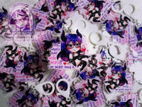 Acrylic double sided keychain with a chibi pink and purple succubus holding a love potion. This photo shows the keychains.