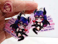 Acrylic double sided keychain with a chibi pink and purple succubus holding a love potion. There is lewd text on the front and back, the text is slightly different. This photo shows the front and back of the keychain.