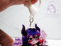 Acrylic double sided keychain with a chibi pink and purple succubus holding a love potion. This photo shows the 2 jump rings and the white plastic keychain finding.